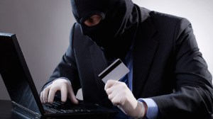 Hacker holding a credit card